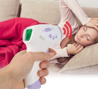 Personne prenant sa température avec un thermomètre frontal